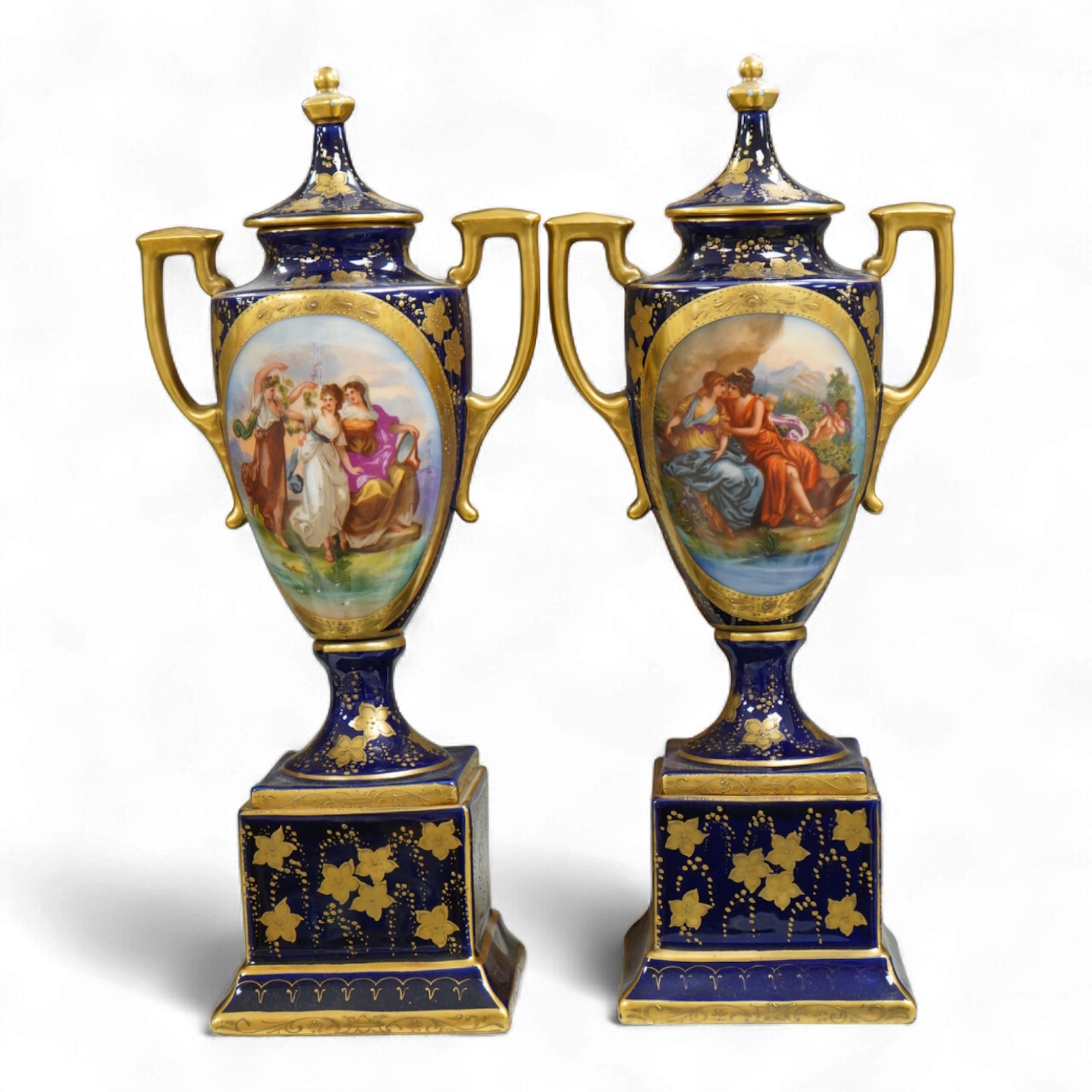 A pair of early 20th century Vienna style porcelain urns and covers, 36cm